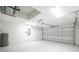 Clean garage featuring a white ceiling, walls, and floor with a gray garage door at 3560 Elias Cir, North Port, FL 34288