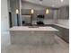 Bright kitchen features gray cabinets, quartz countertops, stainless appliances, and center island with sink at 3560 Elias Cir, North Port, FL 34288