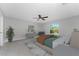 Bright primary bedroom with a ceiling fan, decor furnishings and a view to the yard at 3560 Elias Cir, North Port, FL 34288