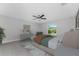 Bright primary bedroom with a ceiling fan, decor furnishings and a view to the yard at 3560 Elias Cir, North Port, FL 34288