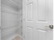This pantry has organized shelving and a door for easy storage at 3560 Elias Cir, North Port, FL 34288