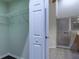 Bathroom view featuring a shower and metal shelving, with a bedroom closet visible through a doorway at 3702 Lakewood Blvd, North Port, FL 34287