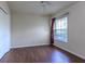 Bedroom featuring wood floors, a ceiling fan, and a window with blinds at 3702 Lakewood Blvd, North Port, FL 34287