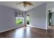 Spacious bedroom with wood floors, ceiling fan and a large window with backyard views at 3702 Lakewood Blvd, North Port, FL 34287