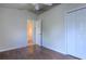 Bedroom featuring wood floors, a ceiling fan, and a double-door closet at 3702 Lakewood Blvd, North Port, FL 34287