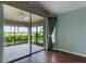 Bright bedroom with access to a screened lanai overlooking a beautiful outdoor view at 3702 Lakewood Blvd, North Port, FL 34287