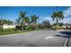 Entrance to Villas of Sabal Trace II with lush foliage and a clear blue sky at 3702 Lakewood Blvd, North Port, FL 34287