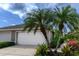 Attractive home exterior with lush landscaping and well-maintained curb appeal at 3702 Lakewood Blvd, North Port, FL 34287
