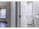 Hallway view leading to the laundry room, featuring a washer and dryer at 3702 Lakewood Blvd, North Port, FL 34287