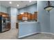 Spacious kitchen featuring a stainless steel refrigerator and ample cabinet storage at 3702 Lakewood Blvd, North Port, FL 34287