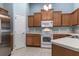 The kitchen features wooden cabinets, stainless steel appliances, and tile floors at 3702 Lakewood Blvd, North Port, FL 34287