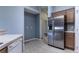 Spacious kitchen area featuring stainless steel refrigerator and tile floors at 3702 Lakewood Blvd, North Port, FL 34287