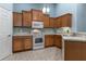 Well-equipped kitchen with wooden cabinets and modern white appliances at 3702 Lakewood Blvd, North Port, FL 34287