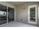 Enclosed lanai with screen windows and sliding doors, showcasing lush green landscape at 3702 Lakewood Blvd, North Port, FL 34287