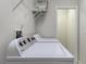 Bright laundry room featuring a Whirlpool washer and dryer with overhead storage space at 3702 Lakewood Blvd, North Port, FL 34287