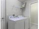 Bright laundry room featuring a Whirlpool washer and dryer and wire shelving unit at 3702 Lakewood Blvd, North Port, FL 34287
