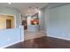 Living room featuring hardwood floors and an open layout view into the kitchen at 3702 Lakewood Blvd, North Port, FL 34287