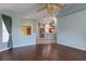 Living room featuring hardwood floors and an open layout view into the kitchen at 3702 Lakewood Blvd, North Port, FL 34287