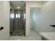 Modern bathroom featuring a glass shower and access to the toilet room at 3920 Wisteria Pl, Punta Gorda, FL 33950