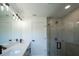 Bright bathroom features a dual sink vanity, modern lighting, and glass-enclosed shower at 3920 Wisteria Pl, Punta Gorda, FL 33950