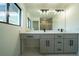 Bright bathroom with double vanity, framed mirror, and sleek fixtures for a luxurious feel at 3920 Wisteria Pl, Punta Gorda, FL 33950