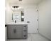 Modern bathroom features a gray vanity, updated lighting, and stylish fixtures at 3920 Wisteria Pl, Punta Gorda, FL 33950