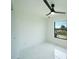 Bright bedroom features a large window, ceiling fan, and white marble floors at 3920 Wisteria Pl, Punta Gorda, FL 33950