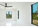 Bright bedroom with natural light, ceiling fan, and marble floors offers comfort and style at 3920 Wisteria Pl, Punta Gorda, FL 33950