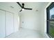 Bright bedroom featuring marble floors, a modern fan, closet, and an abundance of natural light at 3920 Wisteria Pl, Punta Gorda, FL 33950