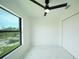 Bright bedroom features a large window, ceiling fan, and spacious closet at 3920 Wisteria Pl, Punta Gorda, FL 33950