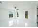Bright bedroom with marble floors, ceiling fan, and natural light from windows creates an open space at 3920 Wisteria Pl, Punta Gorda, FL 33950