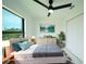 This staged bedroom boasts a large window, comfortable bed, and stylish decor at 3920 Wisteria Pl, Punta Gorda, FL 33950
