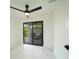 Bright bedroom featuring marble floors, a modern fan, and sliding glass doors to the exterior at 3920 Wisteria Pl, Punta Gorda, FL 33950