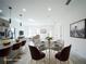 Staged dining area with modern table set, connected to the open-concept kitchen and living room at 3920 Wisteria Pl, Punta Gorda, FL 33950