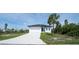 Beautiful single-story home featuring a pristine white exterior and a spacious driveway at 3920 Wisteria Pl, Punta Gorda, FL 33950