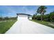 Well-maintained home featuring a long driveway and a clean white exterior with dark window trim at 3920 Wisteria Pl, Punta Gorda, FL 33950