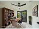 Bright office features marble floors, a modern fan, exterior access, and a bookcase at 3920 Wisteria Pl, Punta Gorda, FL 33950
