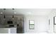 Modern kitchen featuring stainless steel appliances, grey cabinets, and contemporary pendant lighting at 3920 Wisteria Pl, Punta Gorda, FL 33950