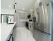 Modern kitchen featuring stainless steel appliances, stylish cabinets, and quartz countertops at 3920 Wisteria Pl, Punta Gorda, FL 33950