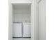 New, white, front-loading Samsung washer and dryer with wire shelving at 3920 Wisteria Pl, Punta Gorda, FL 33950