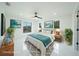 Staged main bedroom with ample natural light, ceiling fan, and elegant decor creates an inviting space at 3920 Wisteria Pl, Punta Gorda, FL 33950