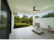 Bright and airy covered patio with white tile flooring and views of the lush green yard at 3920 Wisteria Pl, Punta Gorda, FL 33950