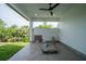 A covered outdoor patio features recessed lighting, a ceiling fan, and views of the lush surrounding landscaping at 3920 Wisteria Pl, Punta Gorda, FL 33950
