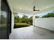 Bright and airy covered patio with white tile flooring and views of the lush green yard at 3920 Wisteria Pl, Punta Gorda, FL 33950