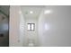 This modern toilet room has a sleek design with a window and contemporary fixtures at 3920 Wisteria Pl, Punta Gorda, FL 33950