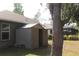 View of backyard shed perfect for extra storage with an open door next to a tree at 4027 Quaker Ln, North Port, FL 34288