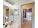 Bright bathroom features a double vanity, large mirror, and ample lighting at 4027 Quaker Ln, North Port, FL 34288