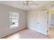 Second bedroom with tile floor, ceiling fan, closet, and natural light at 4027 Quaker Ln, North Port, FL 34288