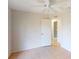 Third bedroom with tile flooring, ceiling fan, and closet at 4027 Quaker Ln, North Port, FL 34288