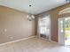 Dining room featuring tile floors, modern chandelier, and natural light from the window at 4027 Quaker Ln, North Port, FL 34288